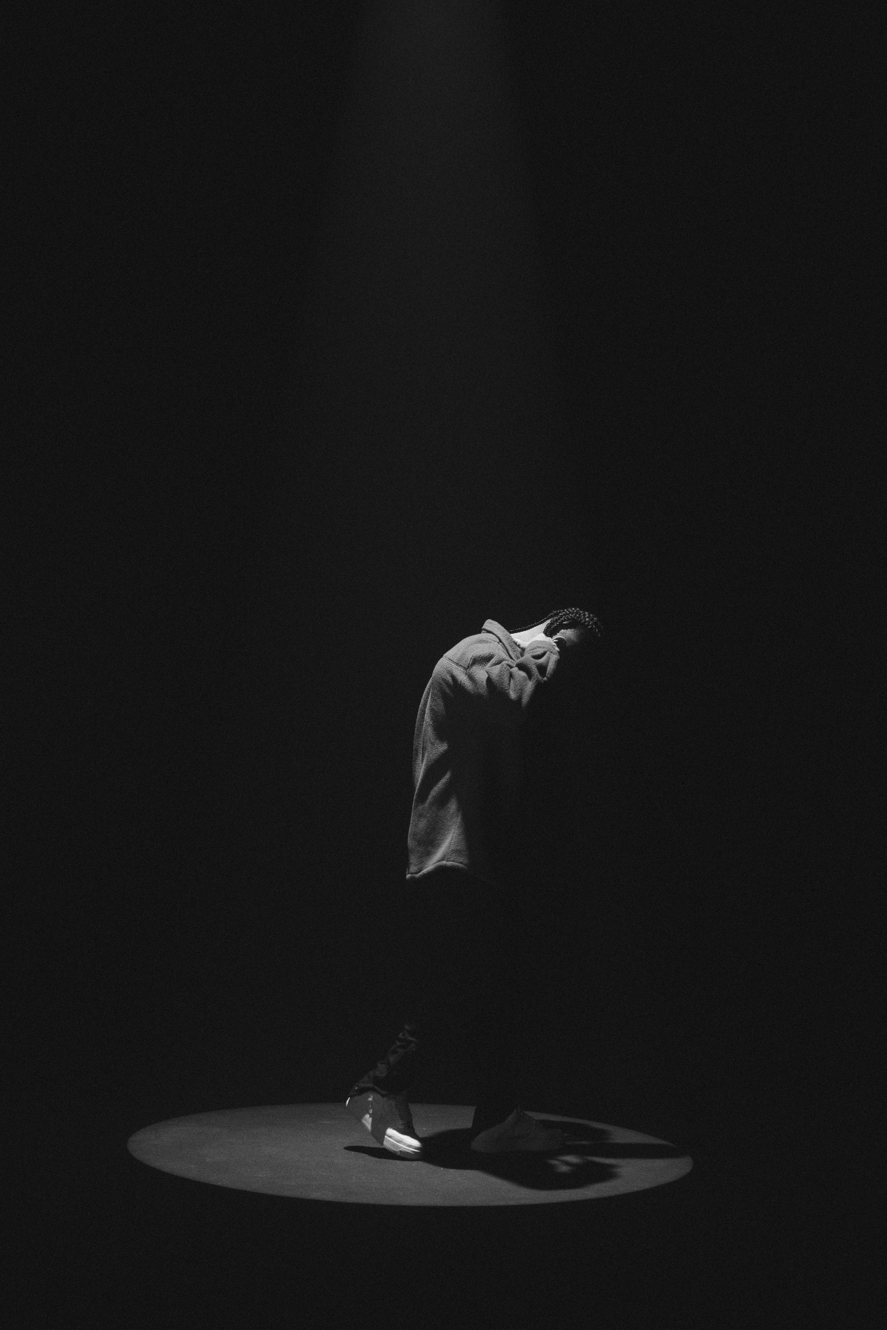 Solitary figure under a beam of light